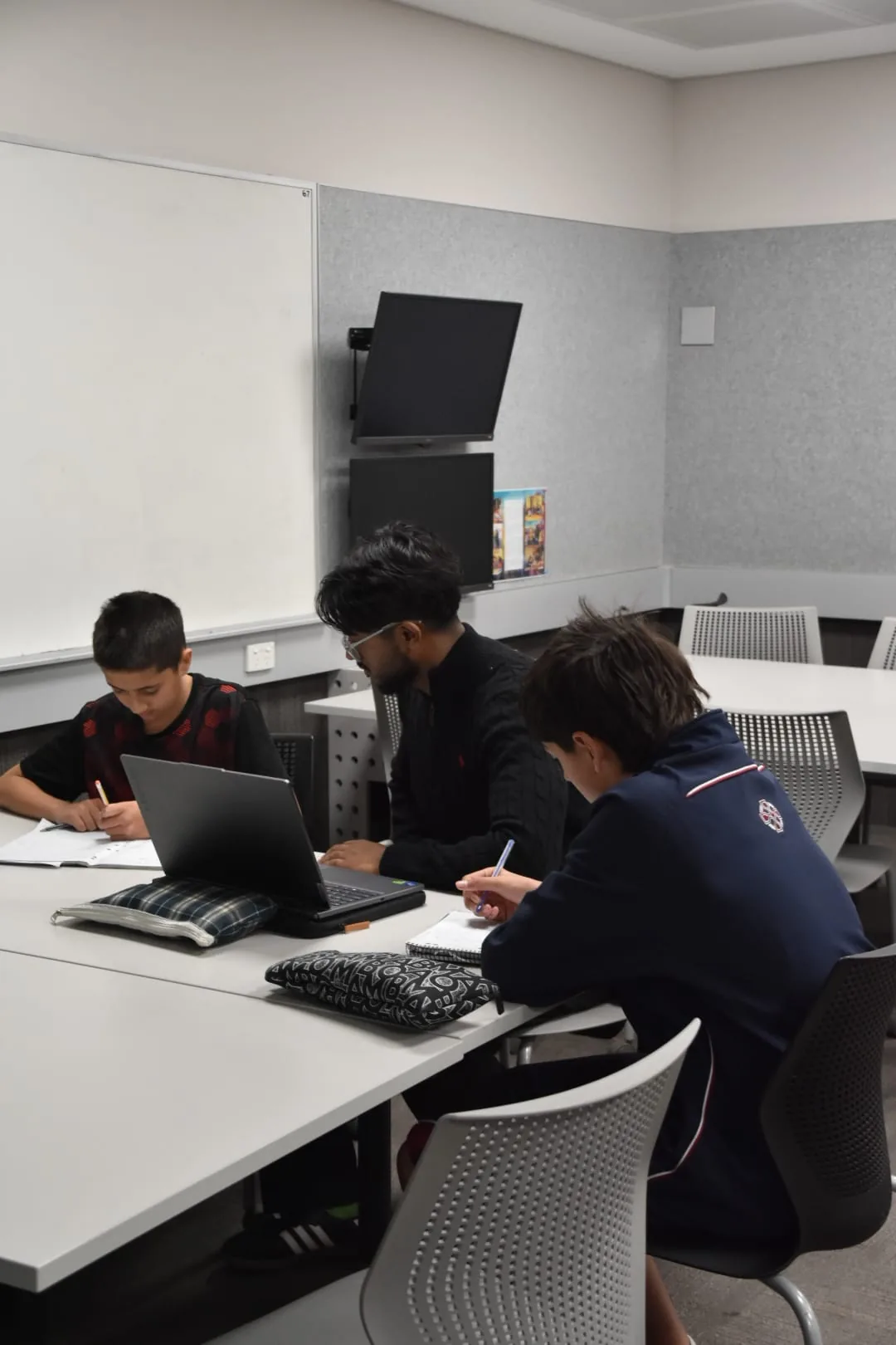 Aventus tutor working with students at a table